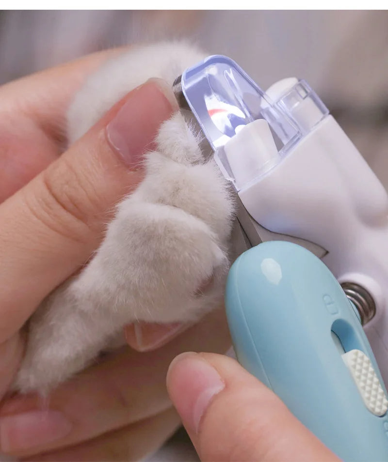 Pet nail clippers LED electric green double lamp in use on cat